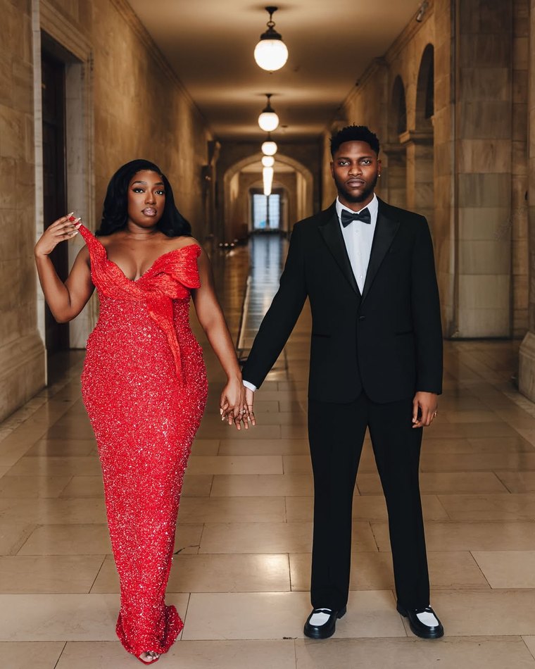 A couple photographed together in a hotel corridor