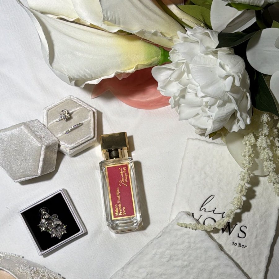 Vow books, perfume and earrings photographed before the ceremony