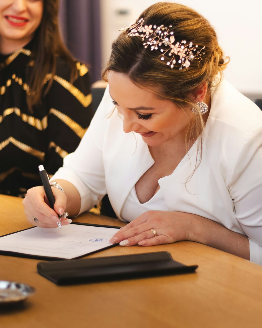 A bride signing her marriage certificate