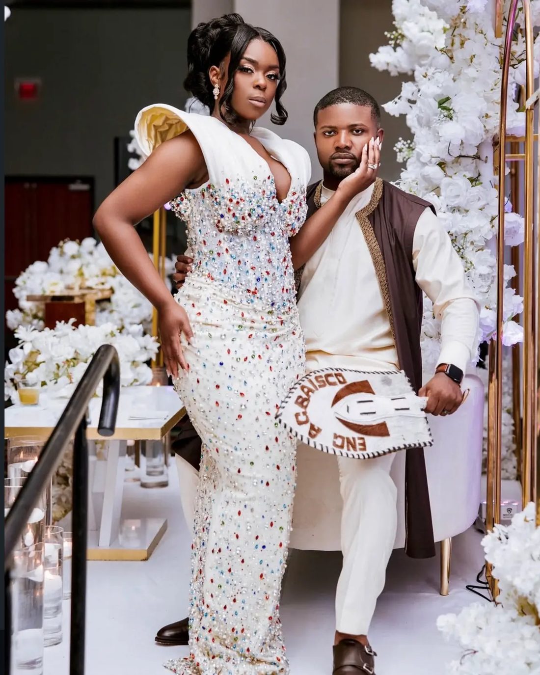 A couple arriving at their traditional ceremony in kente and beaded ivory