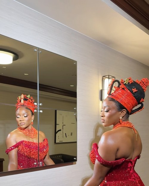 A bride in red with coral beads and a gele