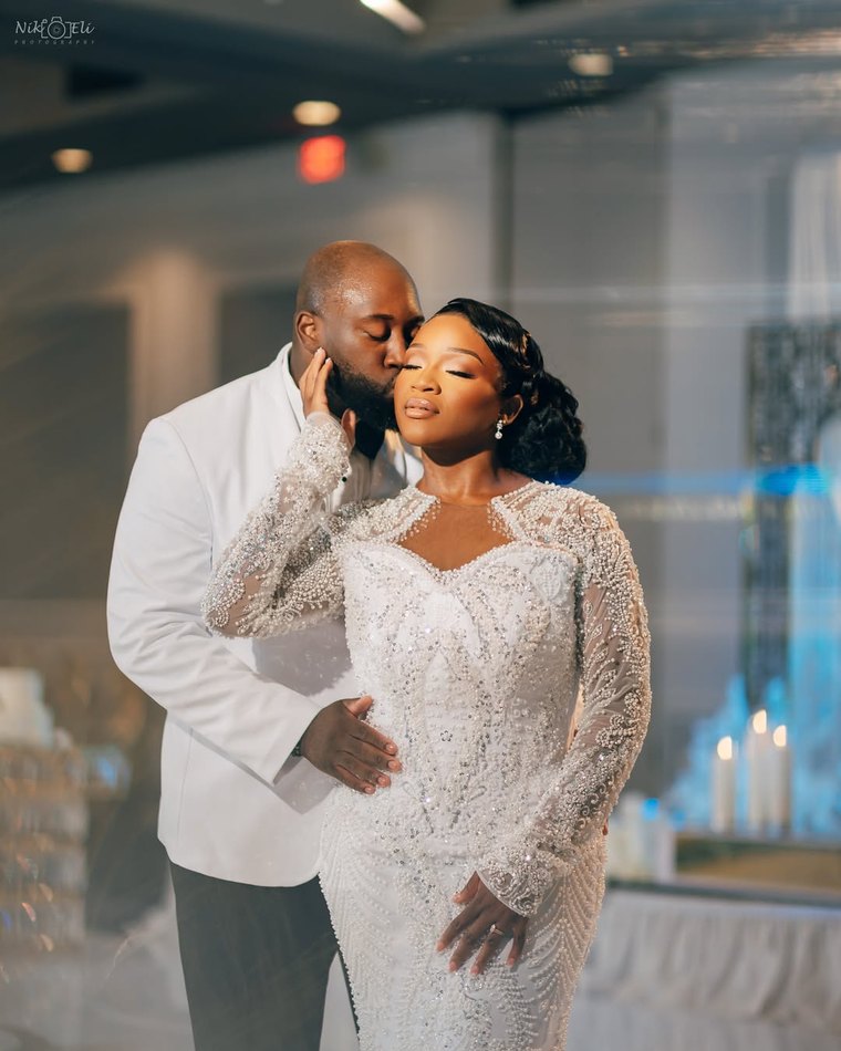 A couple photographed by candlelight at their reception