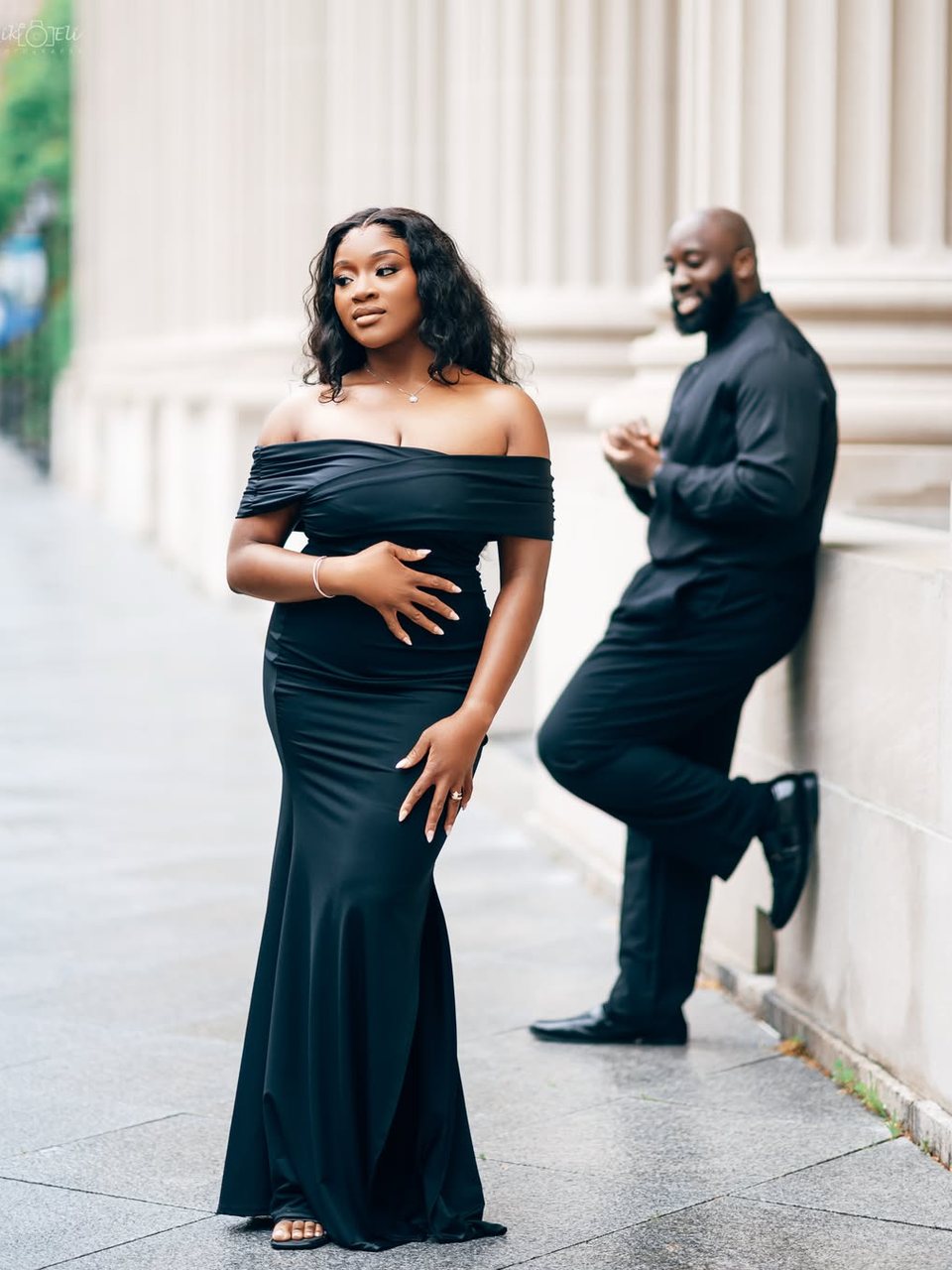 A couple photographed against stone columns