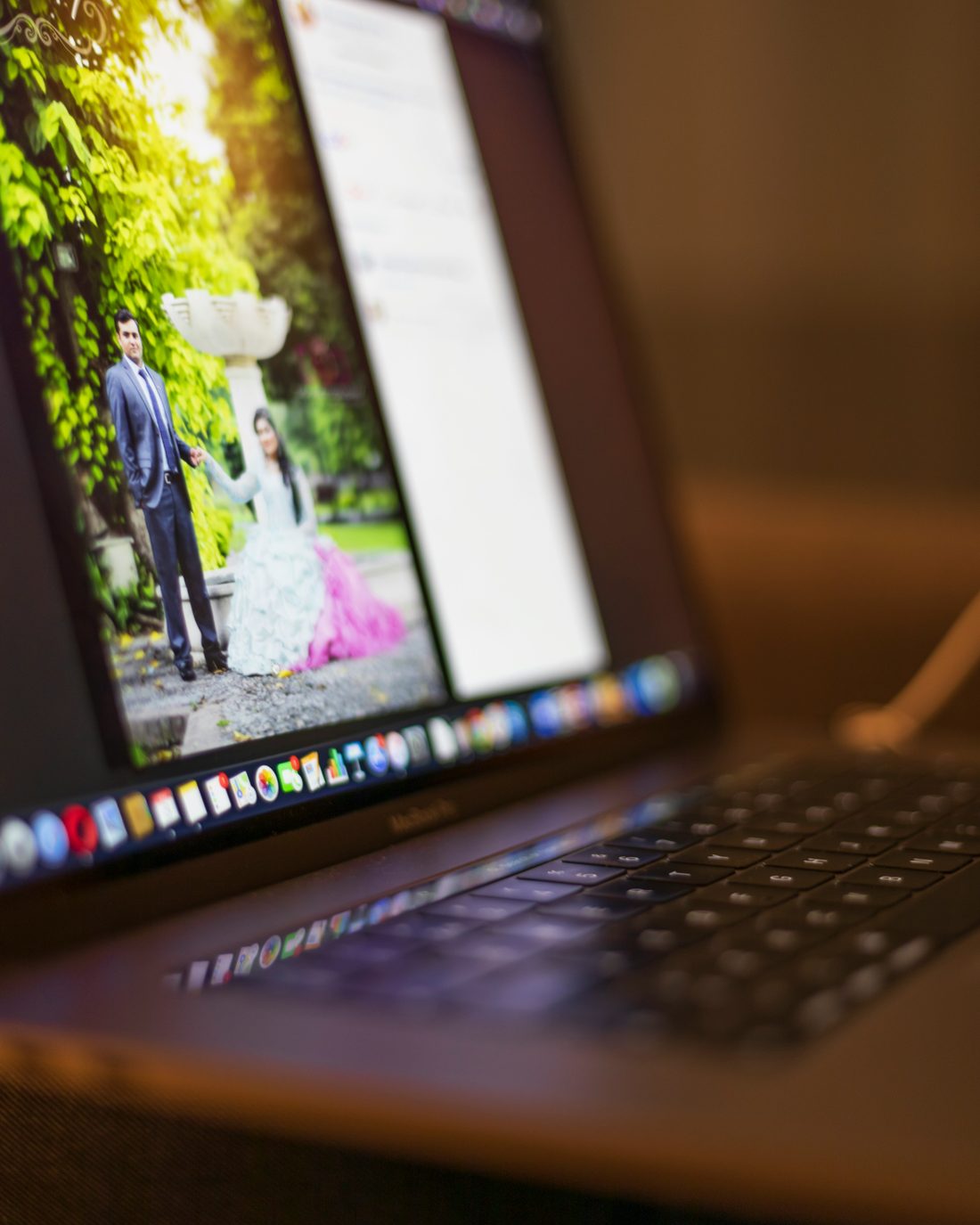 A planner reviewing a couple's photographs at her desk
